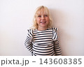 Happy Little Blonde Girl Smiling and Looking Away on White Background 143608385