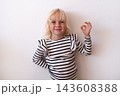 Happy Little Blonde Girl Showing OK Sign and Smiling on White Background 143608388