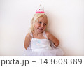 Little Blonde Girl Wearing Princess Crown and Dress on White Background 143608389