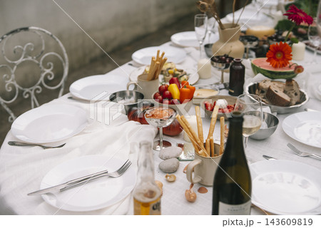 Wine Bottle And Place Settings At Wedding Meal Wine Bottle And Place Settings At Wedding Meal 143609819