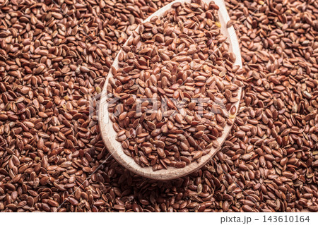 Flax seeds linseed on wooden spoon Flax seeds linseed on wooden spoon 143610164