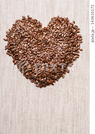 Raw flax seeds linseed heart shaped Raw flax seeds linseed heart shaped 143610172
