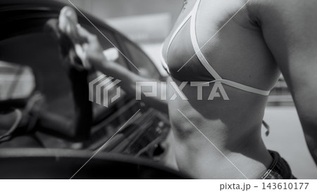 Woman washing car outdoors in sporty casual style Woman washing car outdoors in sporty casual style 143610177