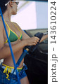 Woman steering a boat on a sunny day 143610224