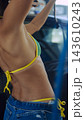 Cropped female torso in colorful bikini and jeans 143610243