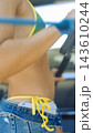 Athletic woman exercising in swimwear outdoors 143610244