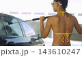Woman washing car with pressure washer outdoors 143610247