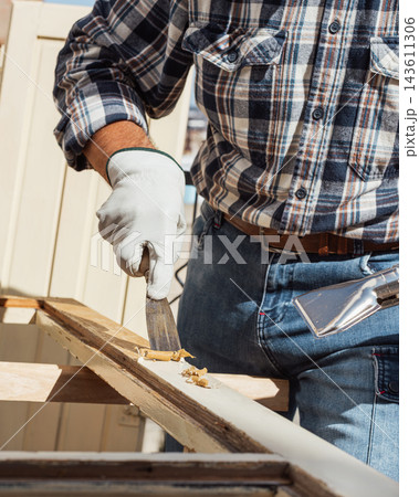Carpenter at work, restoring an old wooden window. Carpentry. Carpenter at work, restoring an old wooden window. Carpentry. 143611306