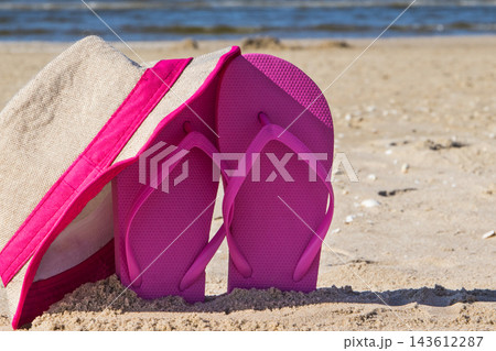 Accessories for relax on beach. Straw hat and flip flop. Summertime Accessories for relax on beach. Straw hat and flip flop. Summertime 143612287