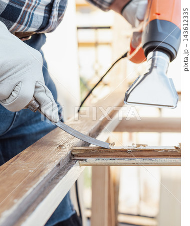 Carpenter at work, restoring an old wooden window. Carpentry. Carpenter at work, restoring an old wooden window. Carpentry. 143612335
