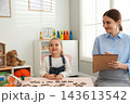 Speech therapist working with little girl in office 143613542