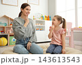 Speech therapist working with little girl in office 143613543