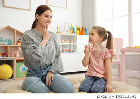 Speech therapist working with little girl in office Speech therapist working with little girl in office 143613543