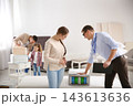 Salesman showing young woman section of mattress in store 143613636