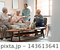 Young woman taking care of elderly people in living room 143613641