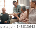 Young woman taking care of elderly people in living room 143613642
