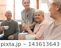 Young woman taking care of elderly people in living room 143613643