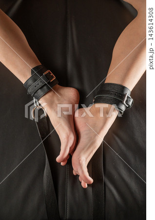 Women's legs in leather shackles. BDSM fetish. 143614308