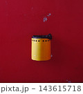 Yellow Trash Bin on Red Wall 143615718