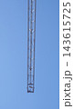 Vertical Tower Crane Mast Against Blue Sky 143615725