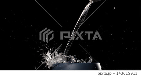 Fresh water pouring into blue dog bowl to help from thirsty. Filling water into pet bowl make splashing droplet around on air floor. Black background isolated, high speed photograph 143615913