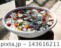 白い陶器の水盤に浮かぶ色とりどりの花 花手水 143616211
