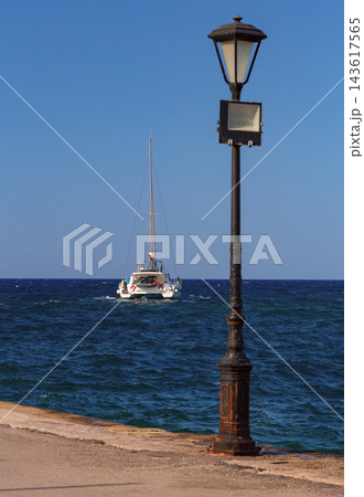 Sailing Catamaran and Street Lamp on Chania Waterfront, Crete, Greece 143617565