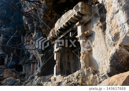Ancient Lycian rock hewn tombs in stone cliff in Pinara, Turkey Ancient Lycian rock hewn tombs in stone cliff in Pinara, Turkey 143617888