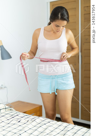 Girl measures her body with centimeter Girl measures her body with centimeter 143617954