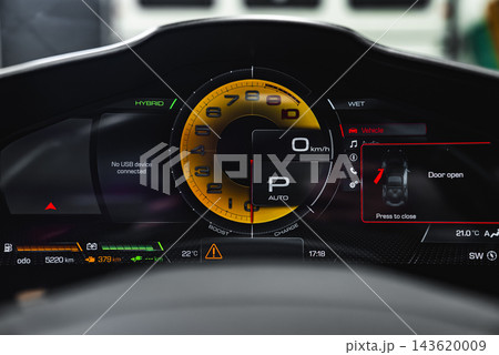 Ferrari Purosangue cluster shows yellow tachometer, hybrid status, wet mode, 0 kmh, gear P auto, door open alert, battery bars, 5220 km, crisp studio lighting. Ferrari Purosangue cluster shows yellow tachometer, hybrid status, wet mode, 0 kmh, gear P auto, door open alert, battery bars, 5220 km, crisp studio lighting. 143620009