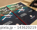 Two glossy Island Skies magazines rest on a table in Male, covers show a red and white seaplane over turquoise reefs, TMA badge visible, warm indoor lighting. 143620219