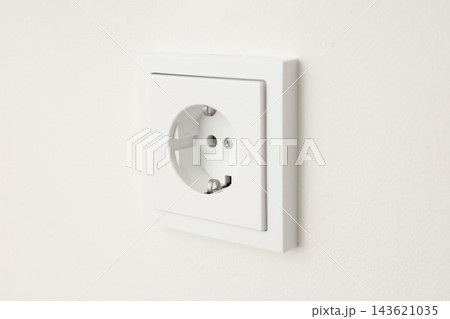 Close up of a clean electrical outlet on a neutral wall 143621035