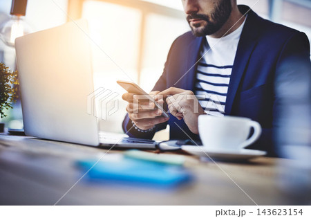 Laptop, coffee and businessman with phone in cafe for online email communication for corporate review. Freelancer, cappuccino and hr with computer and cellphone for company policy with remote work. Laptop, coffee and businessman with phone in cafe for online email communication for corporate review. Freelancer, cappuccino and hr with computer and cellphone for company policy with remote work. 143623154