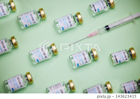 Health, syringe and glass bottle of vaccine by green background, treatment and illness prevention. Medical, insulin and injection for disease, coronavirus and diabetes for immune wellness in studio Health, syringe and glass bottle of vaccine by green background, treatment and illness prevention. Medical, insulin and injection for disease, coronavirus and diabetes for immune wellness in studio 143623415