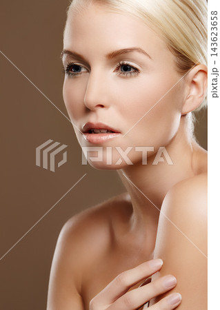Woman, glow and skincare in studio for beauty, foundation and makeup treatment on brown background. Female person, dermatology and confidence for shine, smooth skin and facial wellness for cosmetics Woman, glow and skincare in studio for beauty, foundation and makeup treatment on brown background. Female person, dermatology and confidence for shine, smooth skin and facial wellness for cosmetics 143623658