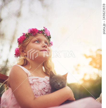 Girl, relax and thinking with kitten for love or furry companion for comfort, friendship and growth or development. Kid, flower crown and cute animal in nature with affection, bonding and playing. 143623659