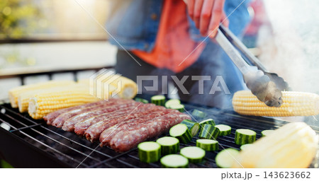 Grill, food and man with sausage and vegetables outdoor backyard for meal at reunion, social event or lunch. Barbecue, party and male person cooking meat and produce for bbq dish on weekend at home Grill, food and man with sausage and vegetables outdoor backyard for meal at reunion, social event or lunch. Barbecue, party and male person cooking meat and produce for bbq dish on weekend at home 143623662