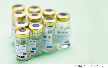 Medical, Covid vaccine and bottle in studio, emergency health care for pandemic. Green background, glass container and medicine with research for virus, chemistry development for human wellness Medical, Covid vaccine and bottle in studio, emergency health care for pandemic. Green background, glass container and medicine with research for virus, chemistry development for human wellness 143624375