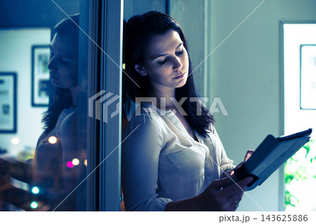 Woman, tablet and working in office and night, deadline for online and digital presentation in corporate company. Research, browsing for information in professional workspace, tired and overtime Woman, tablet and working in office and night, deadline for online and digital presentation in corporate company. Research, browsing for information in professional workspace, tired and overtime 143625886