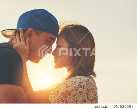 Sunset, couple and hug on beach with forehead touch for care and love in nature with sunshine. Happiness, man and woman outdoor for travel, adventure and holiday to Thailand for vacation in summer Sunset, couple and hug on beach with forehead touch for care and love in nature with sunshine. Happiness, man and woman outdoor for travel, adventure and holiday to Thailand for vacation in summer 143626597
