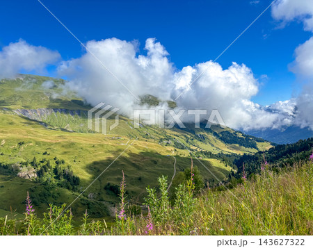 Cloudy mountain slopes above alpine meadows in Les Contamines-Montjoie, France Cloudy mountain slopes above alpine meadows in Les Contamines-Montjoie, France 143627322