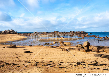 Sandy bay with granite reefs and tidal pools in Tregastel, France Sandy bay with granite reefs and tidal pools in Tregastel, France 143627343