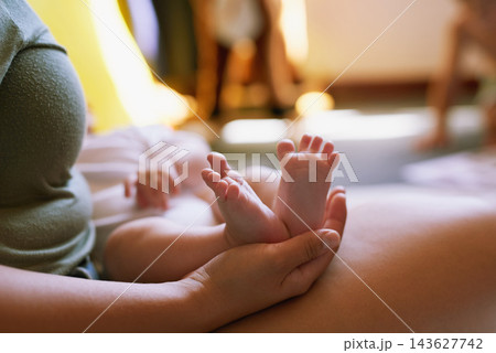 Woman, newborn and feet in home for bonding with love, resting and relaxing or sleep on mother for relationship care. Support, security and trust with family together, motherhood and parent in house 143627742