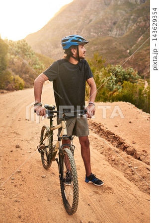 Cyclist, thinking and man with bike on mountain for outdoor exercise, journey and training in morning. Fitness, idea and person with bicycle in nature for health, wellness and cycling in Scotland 143629354