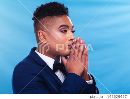 Gay man, fashion and thinking in studio with daydream, vision and memory in formal style by blue background. Queer person, lgbtq model and ideas in suit, trendy and elegant clothes with makeup 143629457