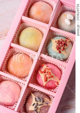 Asian Japanese mochi dessert in various colors and fruit flavors. Mochi dessert Asian Japanese mochi dessert in various colors and fruit flavors. Mochi dessert 143629756