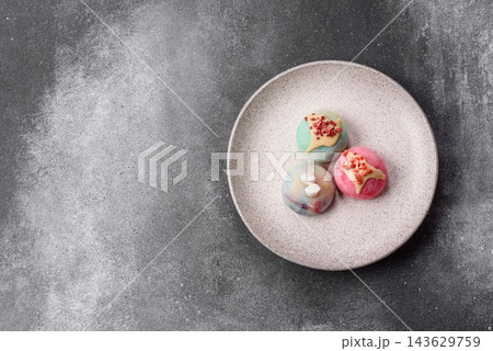 Asian Japanese mochi dessert in various colors and fruit flavors. Mochi dessert Asian Japanese mochi dessert in various colors and fruit flavors. Mochi dessert 143629759