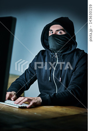 Computer, hacker and portrait of man at night for cyber attack, fraud and digital scam at home. Cybersecurity, crime and male person with technology by table for privacy risk, coding and ransomware 143630159