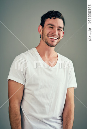 Smile, laughing and portrait of man in studio with funny joke, satisfaction and comedy meme. Relax, male person and face with happiness for humor, good mood and confidence on gray background 143630548