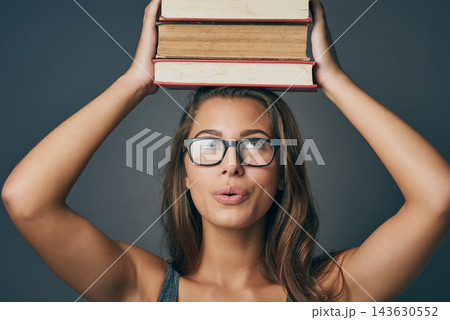 Woman, head and balance books in studio for learning, education or studying isolated on background. Student, university or thinking of research with textbook for knowledge, information or scholarship Woman, head and balance books in studio for learning, education or studying isolated on background. Student, university or thinking of research with textbook for knowledge, information or scholarship 143630552